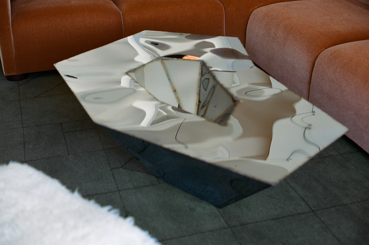 Julian Mayor’s Lunar Table, 2013, in mirror polished stainless steel alights a custom Chroma wool rug by Mark Nelson.