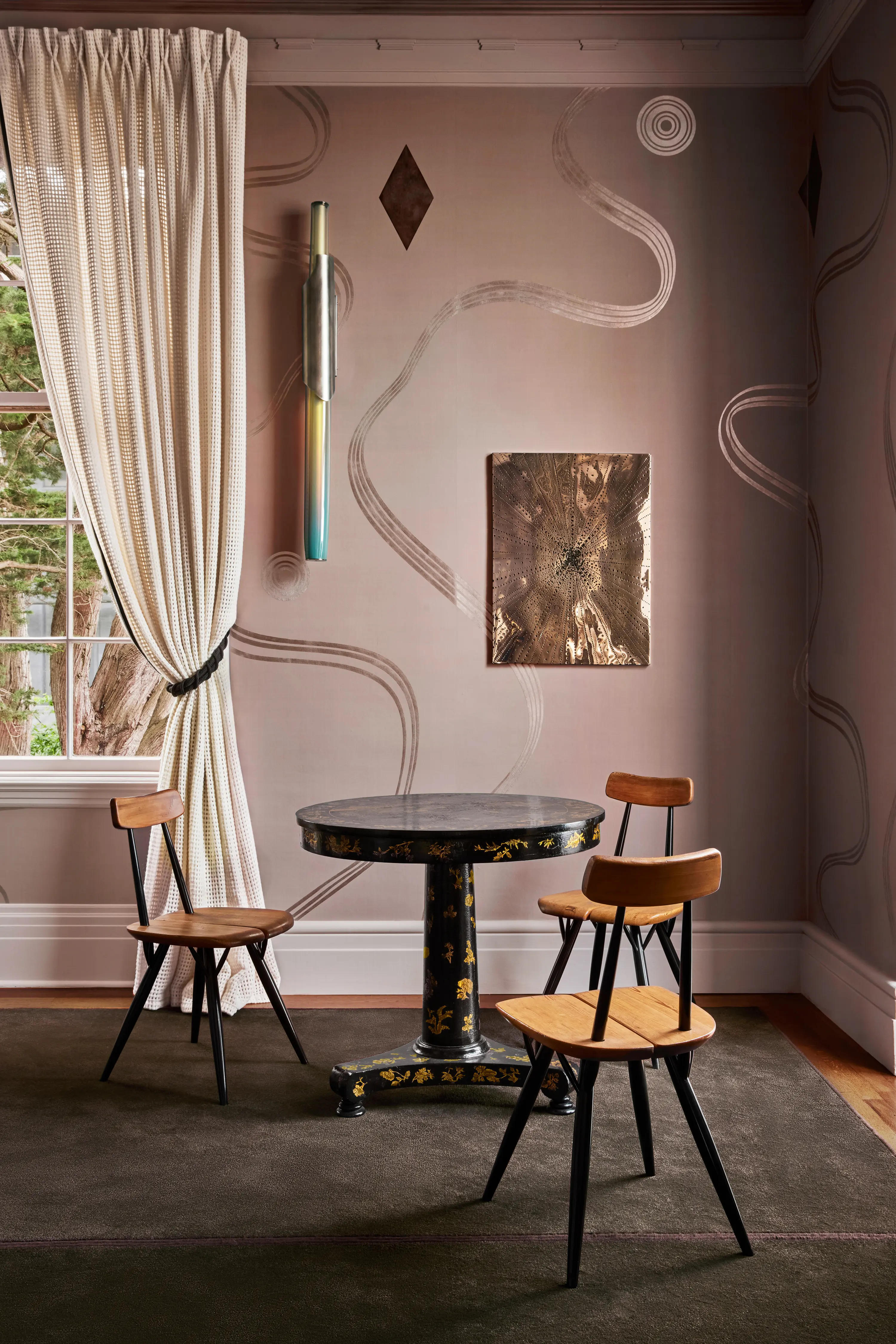 Ilmari Tapiovaara “Pirkka” dining chairs in pine and black lacquered wood array an English Regency chinoiserie black and parcel-gilt lacquered table in the reach of a Davina Semo bronze.