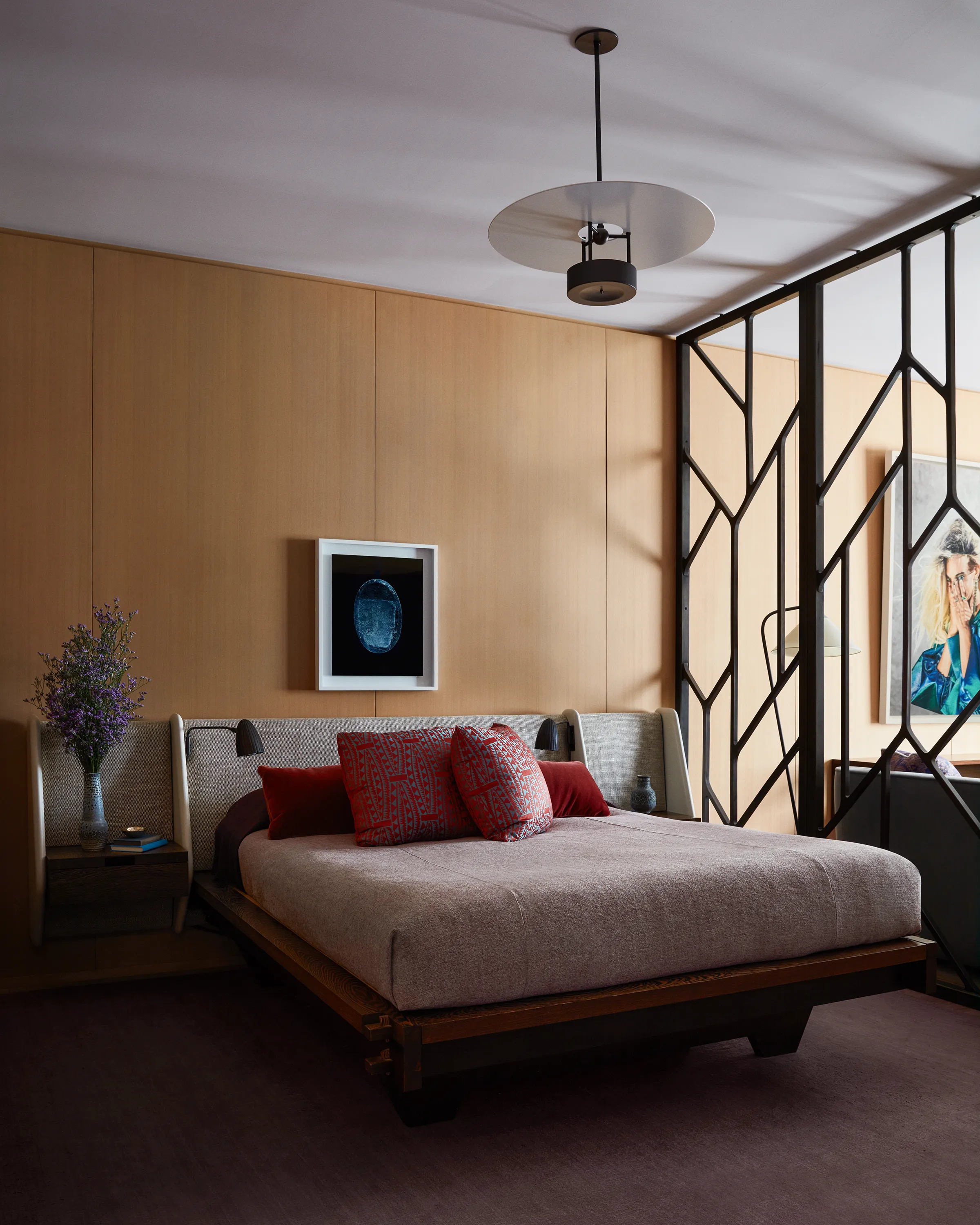 A wenge wood bed frame and custom Chroma headboard in Claremont linen with built-in vintage Böhlmarks sconces, c. 1940s, reposes below a vintage Arne Jacobsen pendant light and a unique ilfochrome by Richard Learoyd.