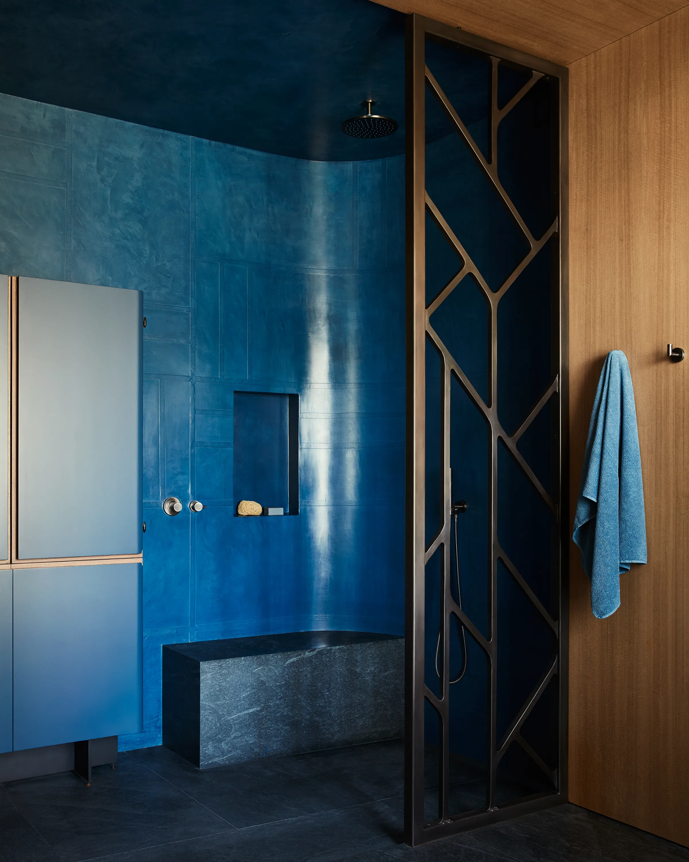 A bespoke Tadelakt Shower by Color Atelier steeps the motif of a Chroma x Wyatt Studio metal screen in saturated hues.